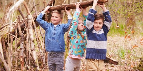 children building a den in the woods