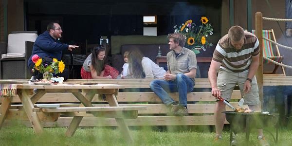 Group of family and friends outside glamping tent