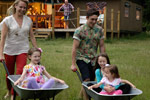 Kids having fun rides in the wheel barrow